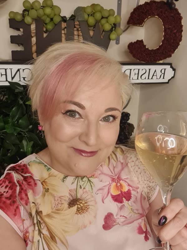 Cecile-blonde-smiling-+-glass-of-bubbly